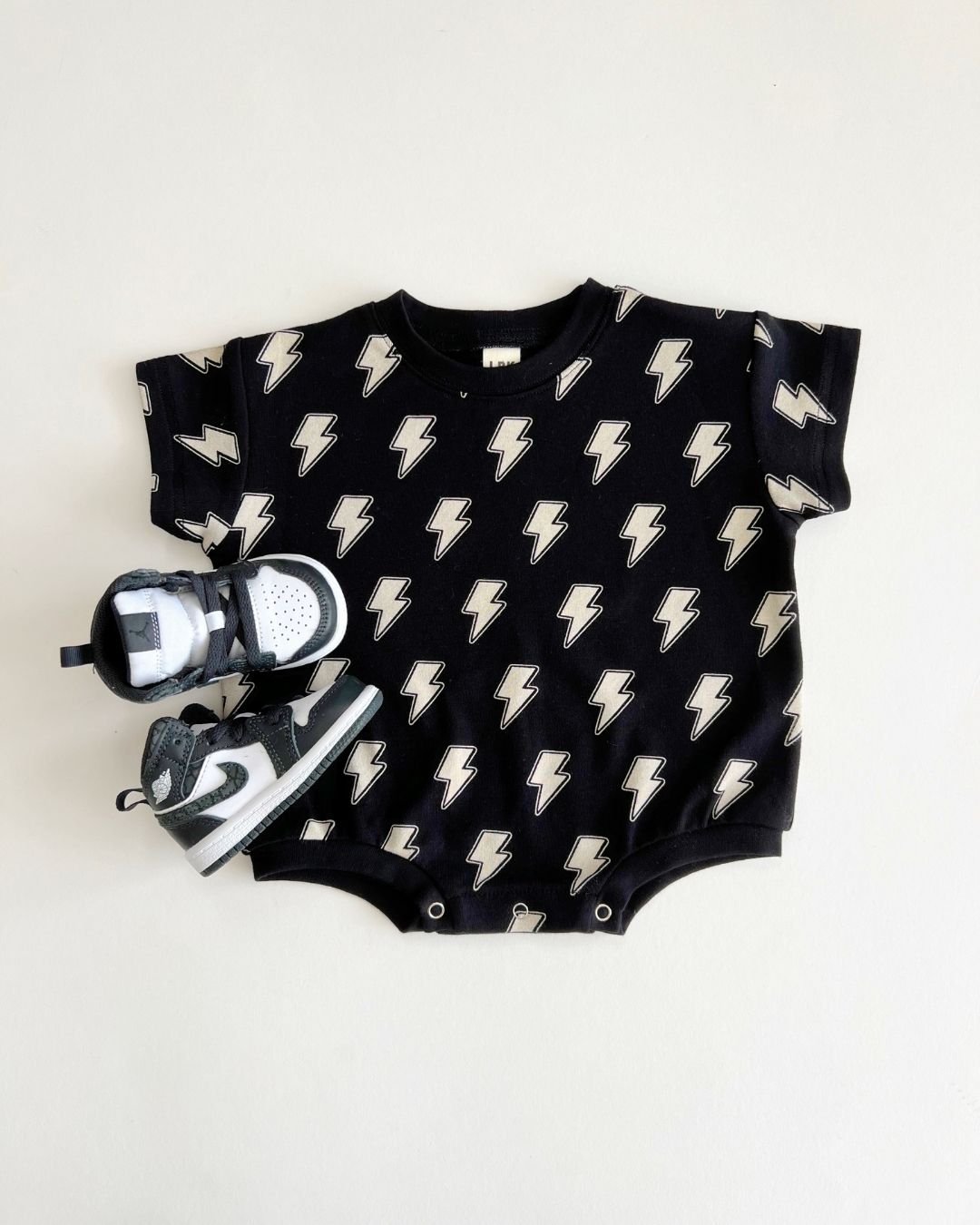 Short Sleeve Bubble Romper | Black Bolts - HoneyBug